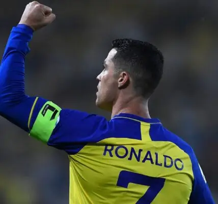 Cristiano Ronaldo disappointed after Al-Nassr’s shocking exit from the tournament, standing on the field with a tense expression.