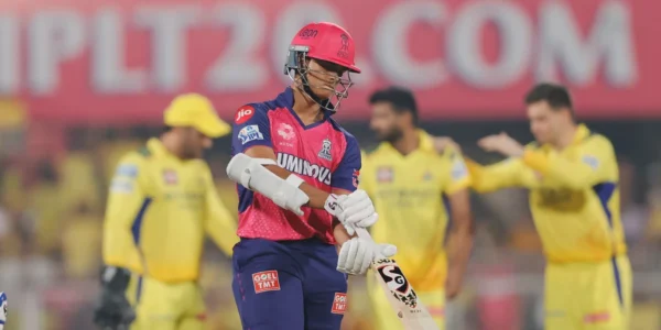 CSK players look disappointed after their IPL 2025 loss to Rajasthan Royals, while RR players celebrate in the background at a packed stadium