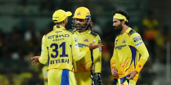 An intense MI vs CSK cricket match in a packed stadium, with a batsman playing a powerful shot while the wicketkeeper is ready behind the stumps. Fans cheer as the stadium lights shine brightly.