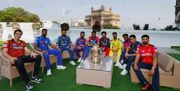"IPL 2025 trophy with team captains standing together before the tournament's opening match."